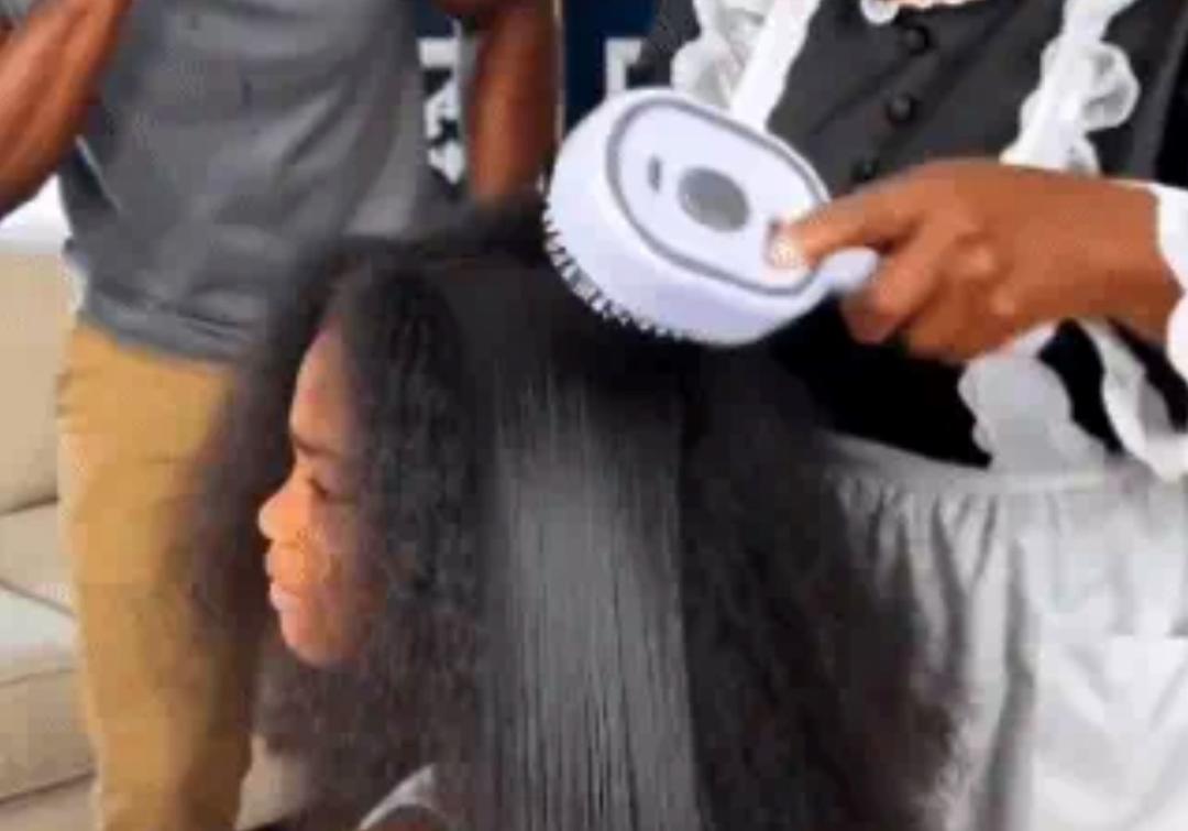 screenshot-from-a-promotional-clip-showing-the-electric-spray-air-cushion-massage-comb-appearing-to-instantly-straighten-heav-c392e.jpg